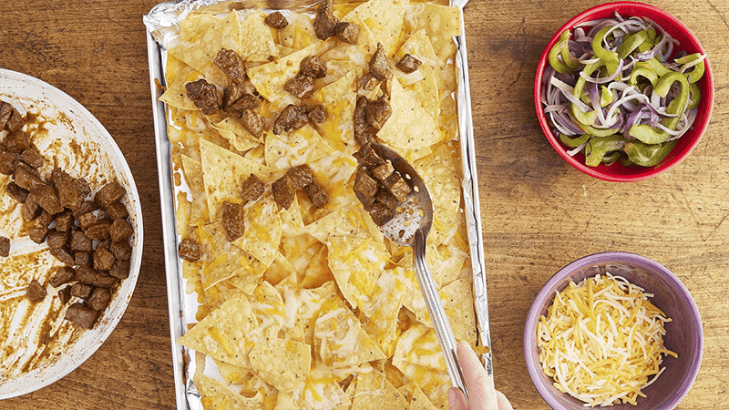steak fajita nachos with shredded cheese & pepper onion salad