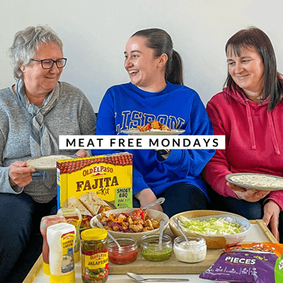 three women having fun together & enjoying fajita meal
